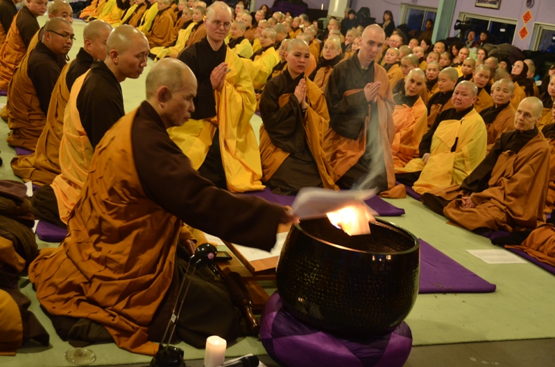 Thay Burning the New Year's Prayer in the Bell, after it has been read out loud (2013).