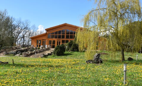 Upper Hamlet meditation hall surrounded by flowers