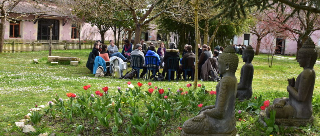 Speaking circle in the Buddha garden full of flowers